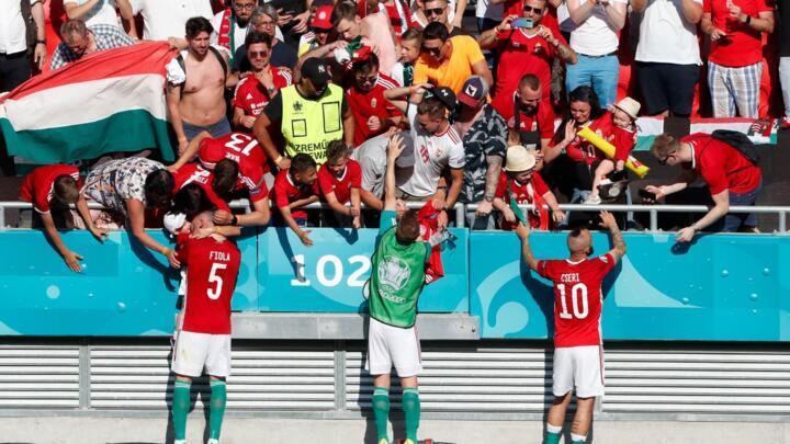 Hungary's Attila Fiola and Tamas Cseri celebrate with fans after their Euro 2021 Group F draw with France at Puskas Arena in Budapest, Hungary, June 19, 2021.